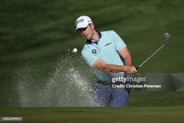 Luke List chips from the bunker onto the second green during the final round of the Waste Management Open at TPC Scottsdale on February 02, 2020 in...