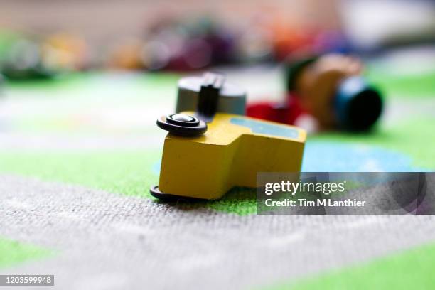 child's toys scattered on carpet - messy playroom stock-fotos und bilder