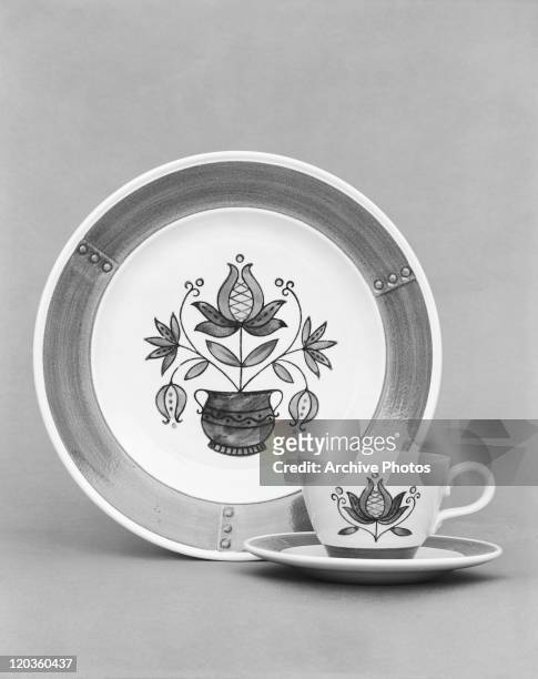 Floral pattern plate, cup and saucer against grey background, close-up
