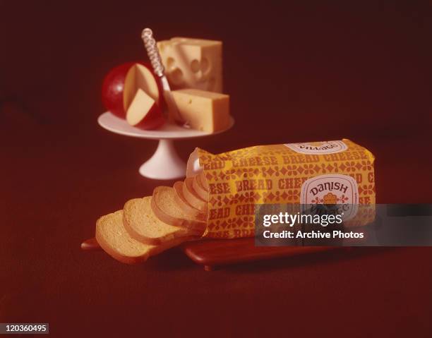 Packed bread slices, apple, cheese, and butter on red background