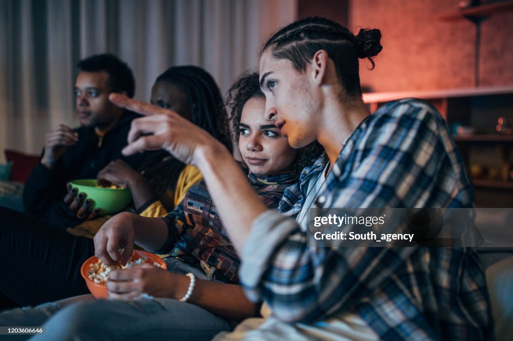 Multi-ethnic friends watching TV