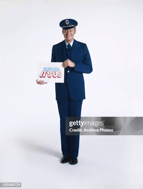 Driver holding Greyhound bus service sign board, smiling, portrait