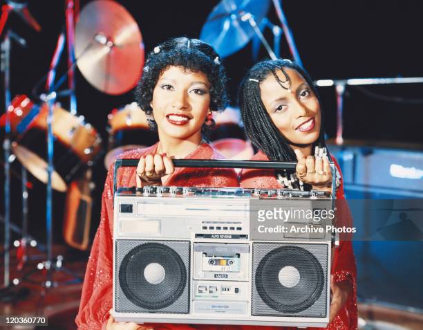Performers holding tape recorder, close-up
