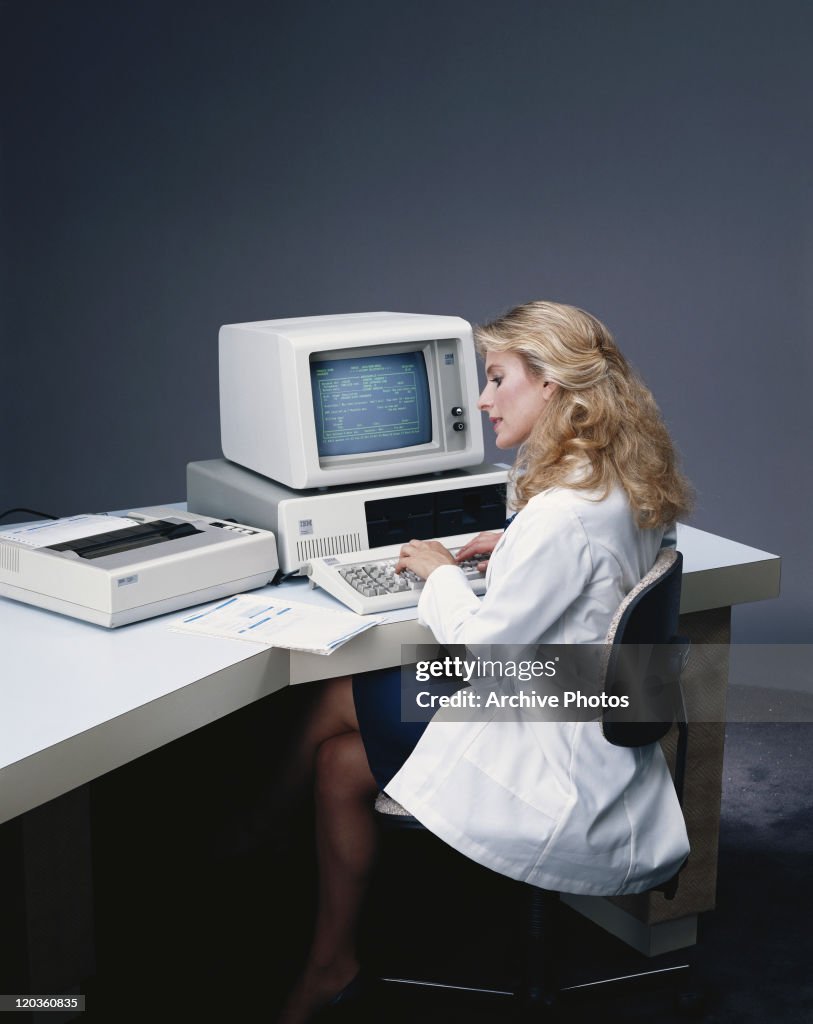 Woman typing on computer keyboard