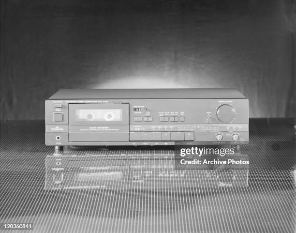 Personal cassette player against black background, close-up