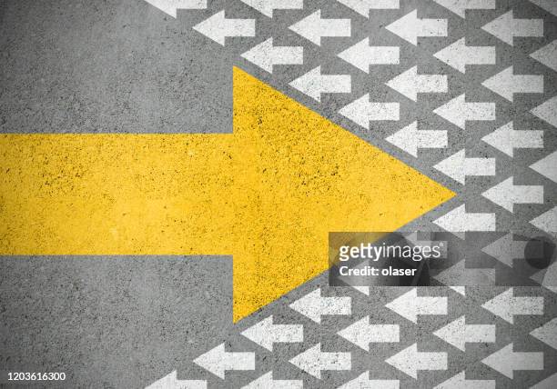 strong yellow (idea) arrow against smaller old white (methods) - leadership concepts stock pictures, royalty-free photos & images