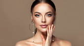 Penetrating look of blue-eyed young woman. Facial treatment, cosmetology, beauty technologies and spa.