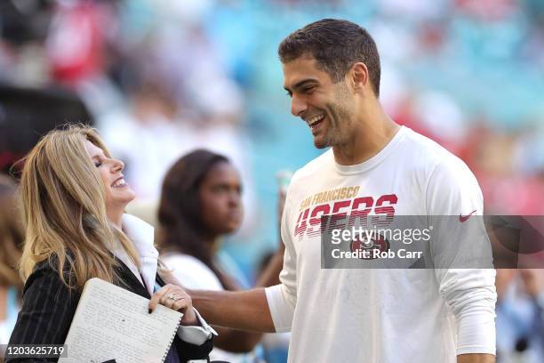 Jimmy Garoppolo of the San Francisco 49ers greets reporter Laura Okmin prior to Super Bowl LIV against the Kansas City Chiefs at Hard Rock Stadium on...