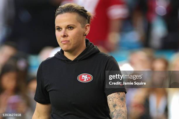 Offensive assistant coach Katie Sowers of the San Francisco 49ers looks during warmups prior to Super Bowl LIV against the Kansas City Chiefs at Hard...