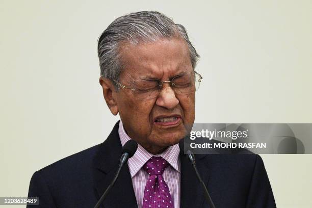 Malaysia's interim Prime Minister Mahathir Mohamad answers questions during a press conference after unveiling an economic stimulus plan aimed at...