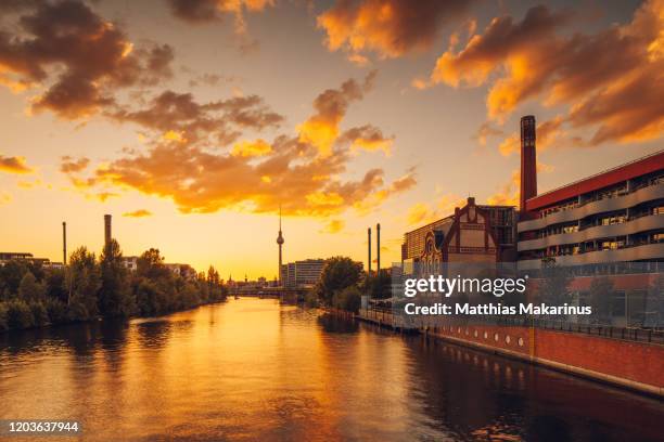 berlin city modern business golden summer spree skyline with sunset and reflection - spree stock-fotos und bilder