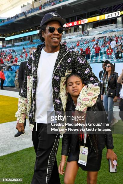 Jay-Z walks with his daughter Blue Ivy Carter as they tour the field before the start of Super Bowl LIV at Hard Rock Stadium in Miami Gardens, Fla.,...