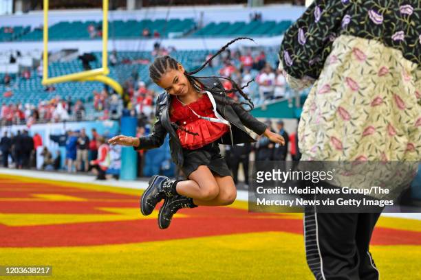 Jay-Z photographs his daughter Blue Ivy Carter as she jumps in the end zone before the start of Super Bowl LIV at Hard Rock Stadium in Miami Gardens,...