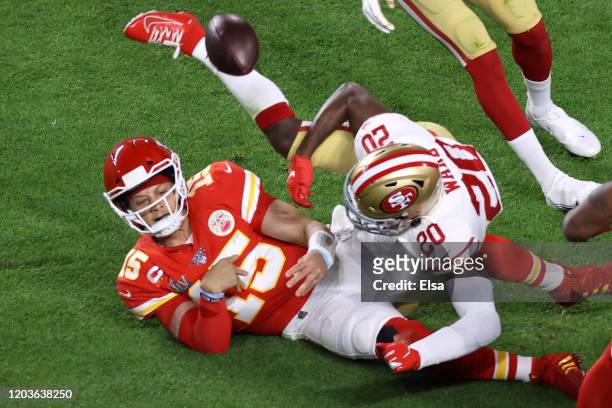 Patrick Mahomes of the Kansas City Chiefs is tackled by Jimmie Ward of the San Francisco 49ers during the first quarter in Super Bowl LIV at Hard...