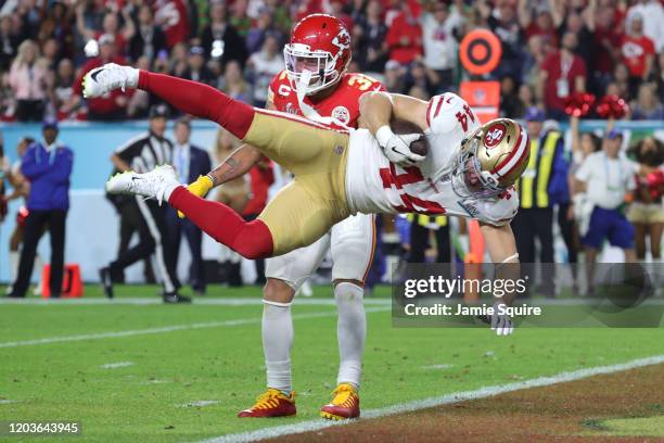 Kyle Juszczyk of the San Francisco 49ers scores on a 15-yard touchdown reception in the second quarter of Super Bowl LIV against the Kansas City...