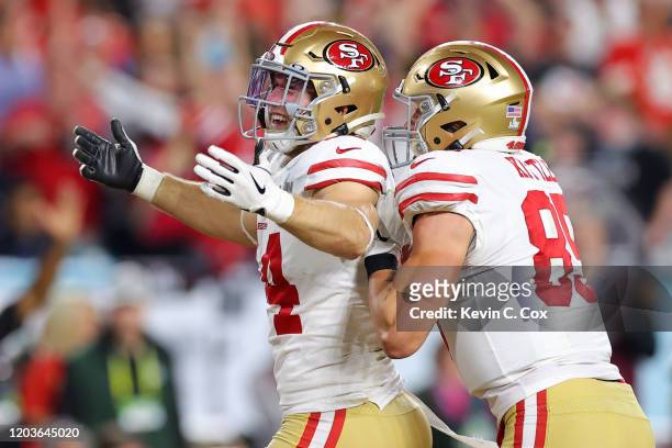 Kyle Juszczyk of the San Francisco 49ers celebrates with George Kittle after scoring a 15 yard touchdown in the second quarter against the Kansas...