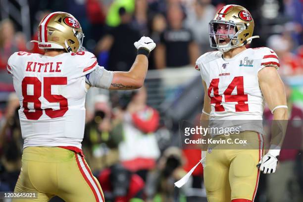 Kyle Juszczyk of the San Francisco 49ers celebrates with George Kittle after scoring a 15 yard touchdown in the second quarter against the Kansas...