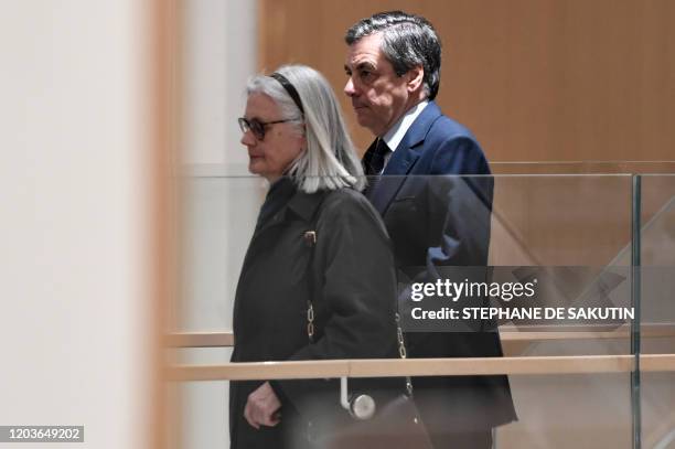 Former French Prime minister Francois Fillon and his wife Penelope arrive at Paris' courthouse, on February 27 for the opening hearing of their trial...