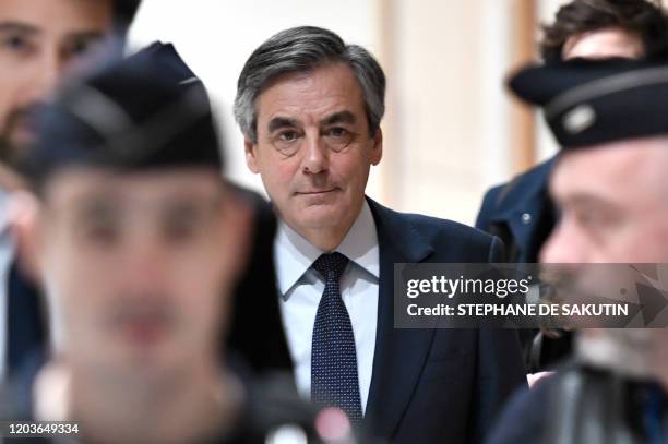 Former French Prime minister Francois Fillon arrives at the Paris' courthouse, on February 27 for the hearing of the trial over claims they embezzled...