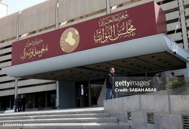 Iraqis stand outside parliament building, or Council of Representatives, in Baghdad's Green Zone on February 27, 2020.