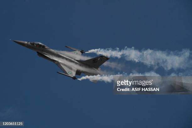 Pakistani fighter jet F-16 flies over Karachi on February 27, 2020 during a ceremony to commemorate Pakistan Air Force's 'Operation Swift Retort'...