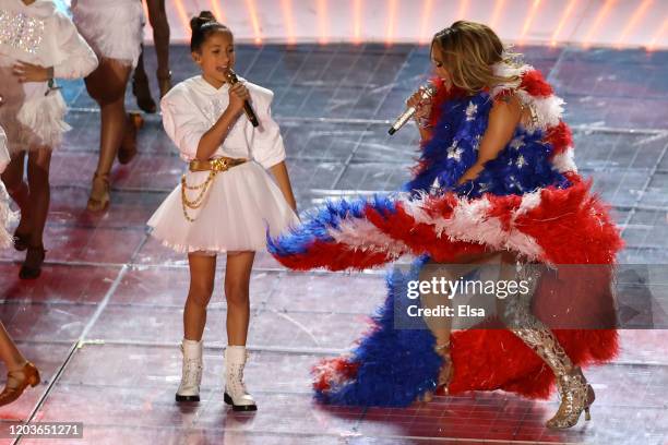 Singer Jennifer Lopez and her daughter Emme Maribel Muñiz perform while a Puerto Rican flag is displayed on stage during the Pepsi Super Bowl LIV...