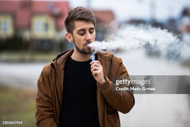 vaping man - e cigarettes stock pictures, royalty-free photos & images