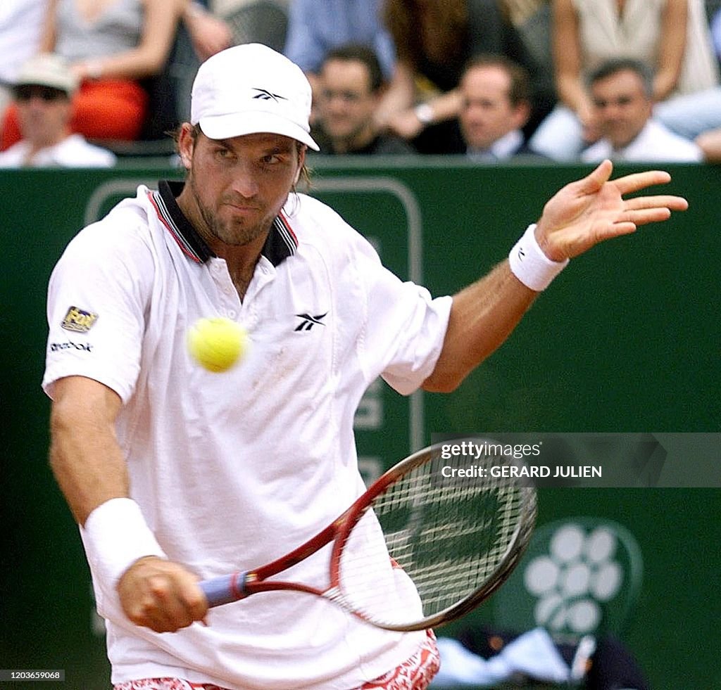 Patrick Rafter Arms Australian player Patrick Rafter hits a backhand to his opponent ...