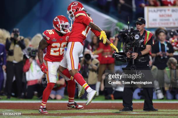 Damien Williams of the Kansas City Chiefs celebrates with Demarcus Robinson after a touchdown against the San Francisco 49ers during the fourth...