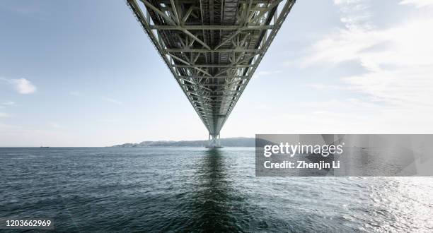 center view of japan kobe akashi-kaikyo bridge over sea / kobe, japan - earthquake bridge stock pictures, royalty-free photos & images