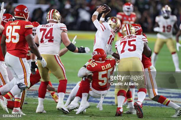 Jimmy Garoppolo of the San Francisco 49ers is sacked by Frank Clark of the Kansas City Chiefs during the fourth quarter in Super Bowl LIV at Hard...