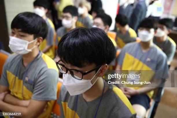 South Korean teenagers wear protective face masks in light of the outbreak of the novel coronavirus, known as 2019-nCoV, during their physical...