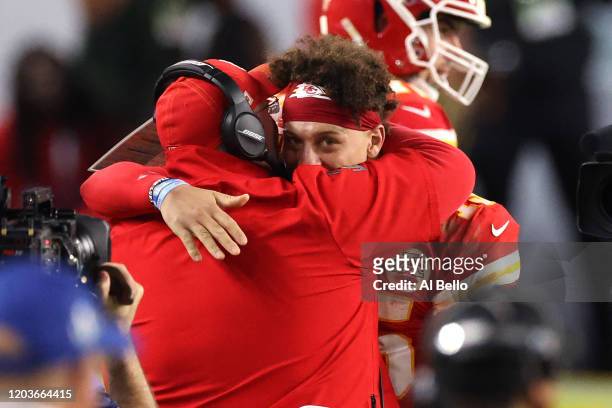 Patrick Mahomes of the Kansas City Chiefs celebrates with head coach Andy Reid after defeating the San Francisco 49ers in Super Bowl LIV at Hard Rock...
