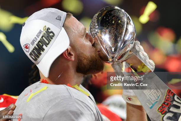 Travis Kelce of the Kansas City Chiefs kisses the Vince Lombardi Trophy after defeating the San Francisco 49ers 31-20 in Super Bowl LIV at Hard Rock...