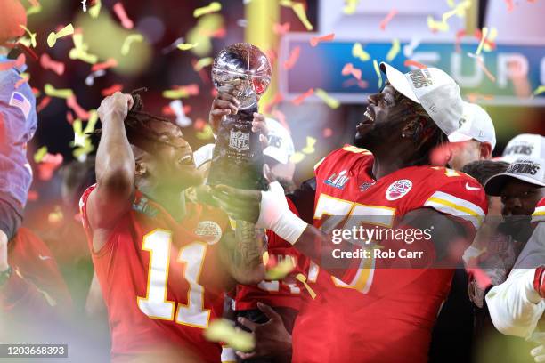 Demarcus Robinson and Cameron Erving of the Kansas City Chiefs celebrate with the Vince Lombardi Trophy after defeating the San Francisco 49ers 31-20...