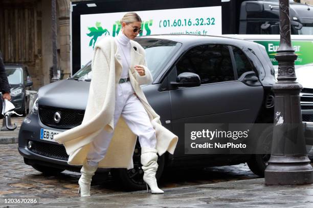 Hailey Bieber is seen wearing creme white cardigan, knitted skirt and top, Bottega bag during Paris Fashion Week Womenswear Fall/Winter 2020/2021 :...