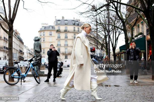 Hailey Bieber is seen wearing creme white cardigan, knitted skirt and top, Bottega bag during Paris Fashion Week Womenswear Fall/Winter 2020/2021 :...