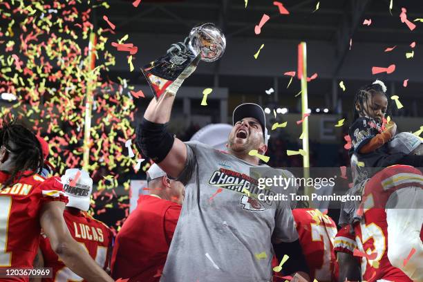 Laurent Duvernay-Tardif of the Kansas City Chiefs raises the Vince Lombardi Trophy after defeating the San Francisco 49ers 31-20 in Super Bowl LIV at...