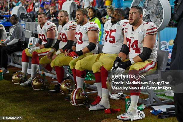 The San Francisco 49ers offensive line sits dejected minutes before the end of the fourth quarter in Super Bowl LIV at Hard Rock Stadium in Miami...