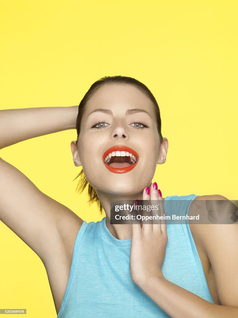 Young female with arm behind head smiling