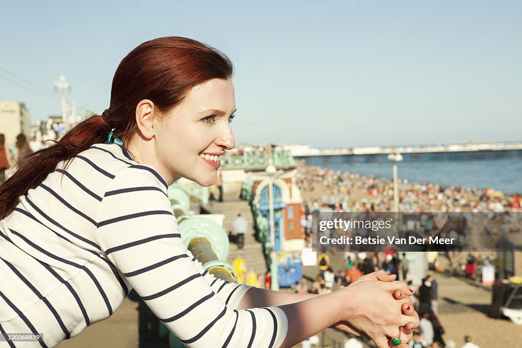 Woman on promenade, overlooking the beach