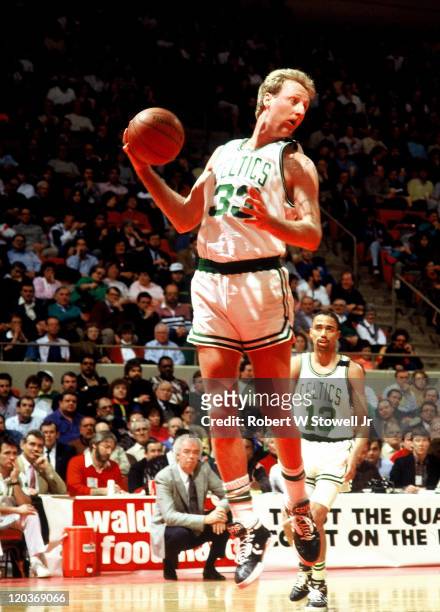 Boston Celtics forward Larry Bird looks up court after rebounding ball during a basketball game, Hartford, CT December 1991. Guard Charles Smith...