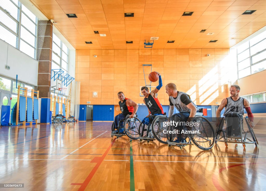 Male Wheelchair Basketball Players Battling Mid Court