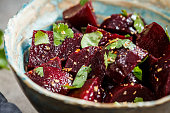 Baked beetroot salad with cilantro in bowl. Healthy vegan food concept.