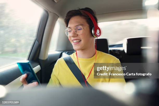 young man on road trip - car listening to music imagens e fotografias de stock
