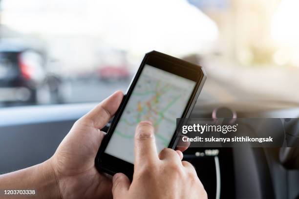 smartphone mapping while in car. - bangkok map stock pictures, royalty-free photos & images
