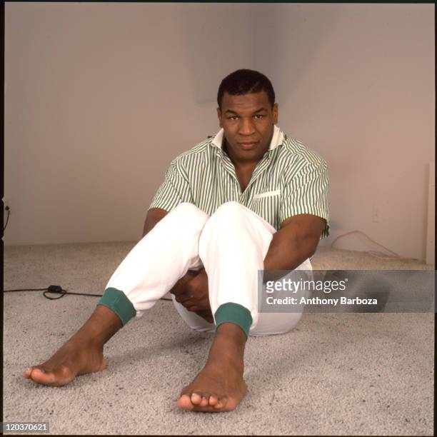 Portrait of boxer Mike Tyson, seated on a carpeted floor, Los Angeles, CA, May 1988.