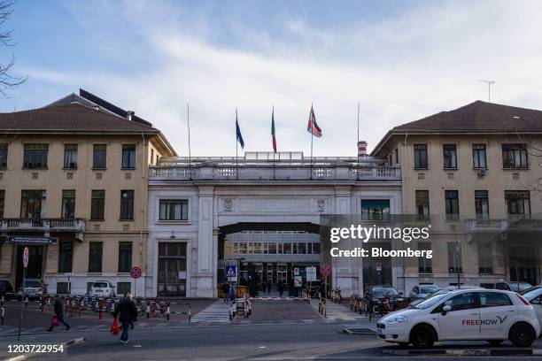 Pedestrians pass Molinette hospital in Turin, Italy, on Thursday, Feb. 27, 2020. As the number of people infected by the coronavirus in Italy rises...