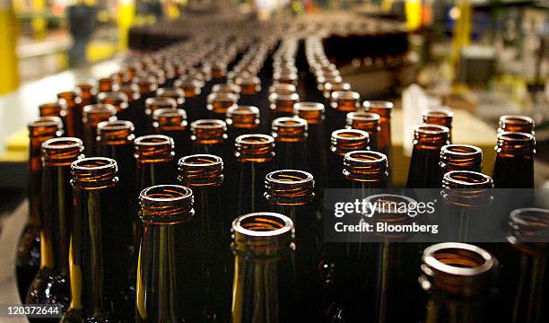 Glass beer bottles move down a conveyor belt at the Owens-Illinois Inc. Glass manufacturing plant in Waco, Texas, U.S., on Thursday, Aug. 4, 2011....