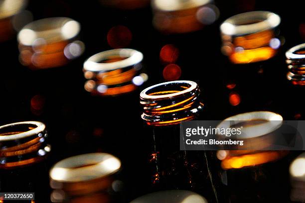 Glass beer bottles stand at the Owens-Illinois Inc. Glass manufacturing plant in Waco, Texas, U.S., on Thursday, Aug. 4, 2011. Owens-Illinois Inc.,...